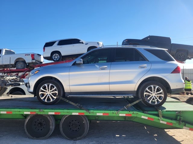 Vehicles lined up at an auction lot for pickup