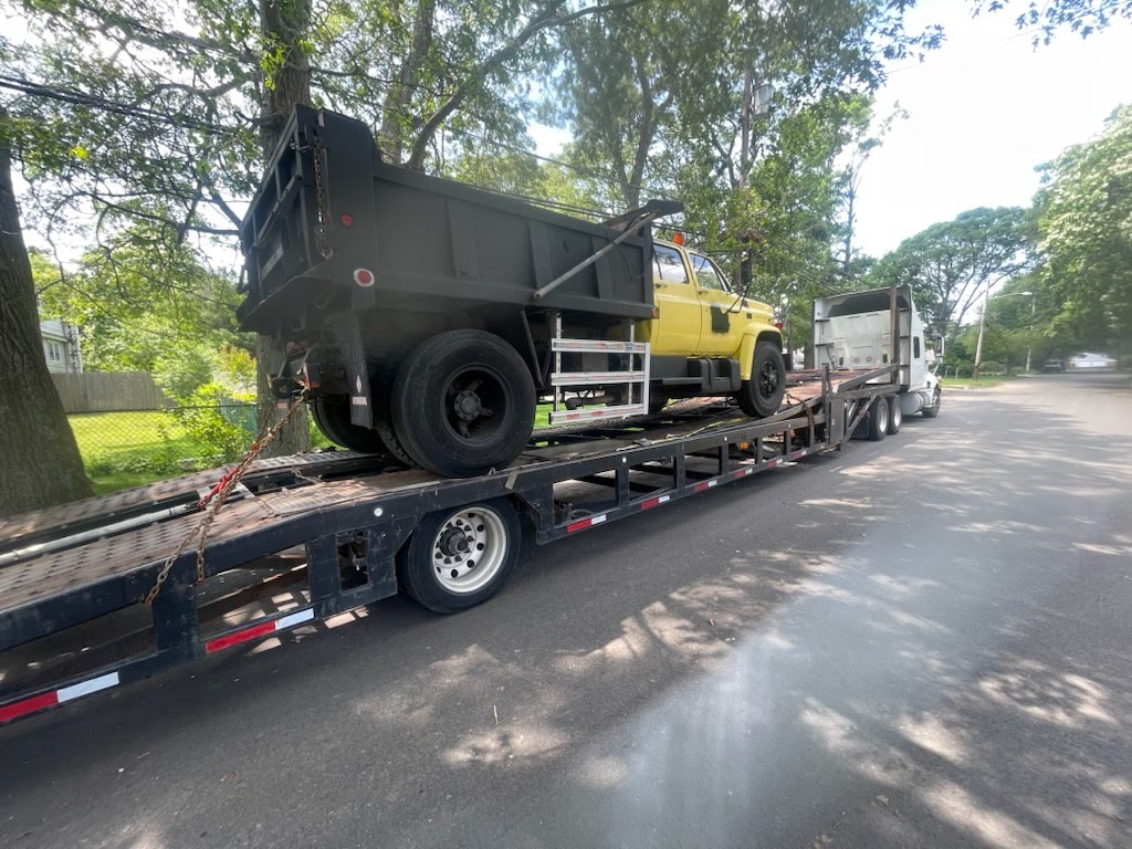 Truck transporting vehicles on an open carrier