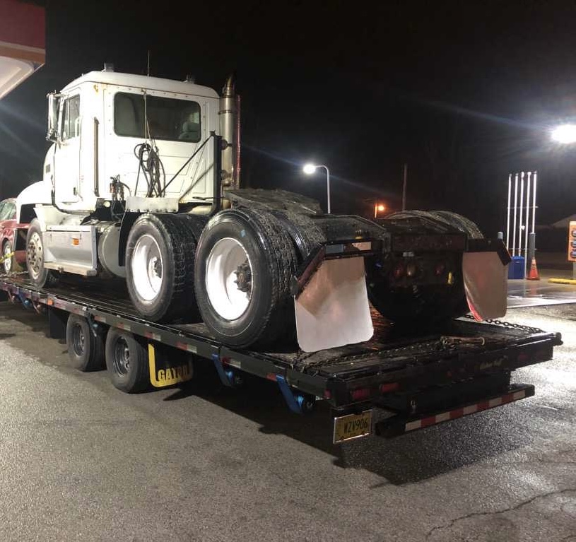 Heavy equipment secured on a specialized flatbed